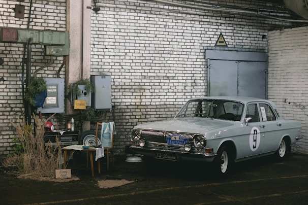 Rustic industrial-themed clothing display with vintage car and rock elements.