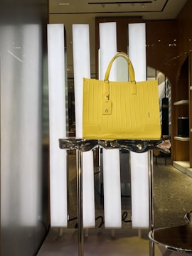 a yellow bag on a white stand