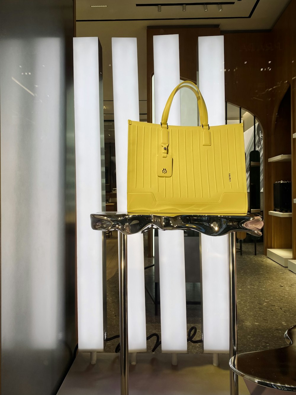 a yellow bag on a white stand