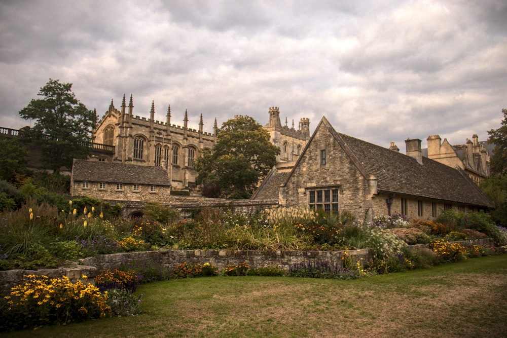 a large stone building with a garden in front of it