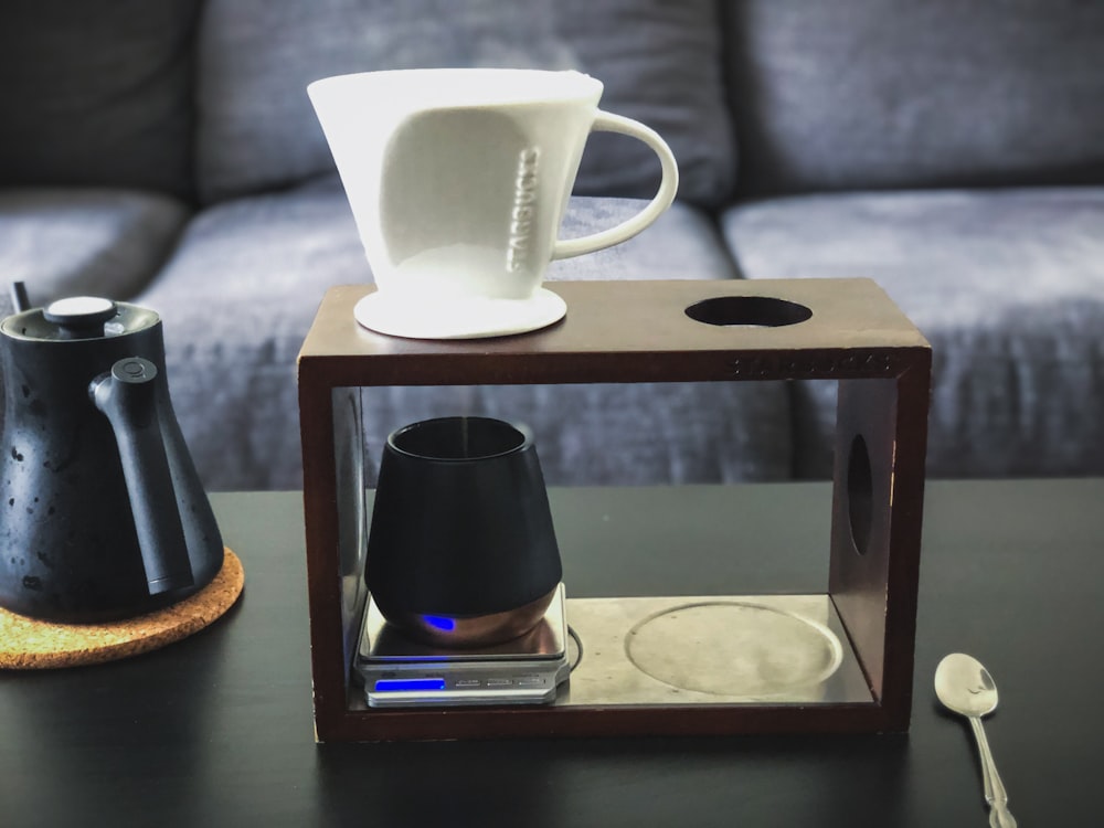 a coffee table with a pitcher and a glass on it