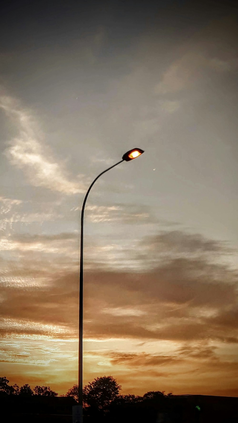 a street light with a cloudy sky