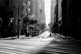 An urban street scene in monochrome with deep shadows and sharp contrasts