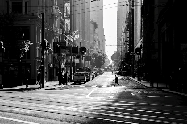 An urban street scene in monochrome with deep shadows and sharp contrasts