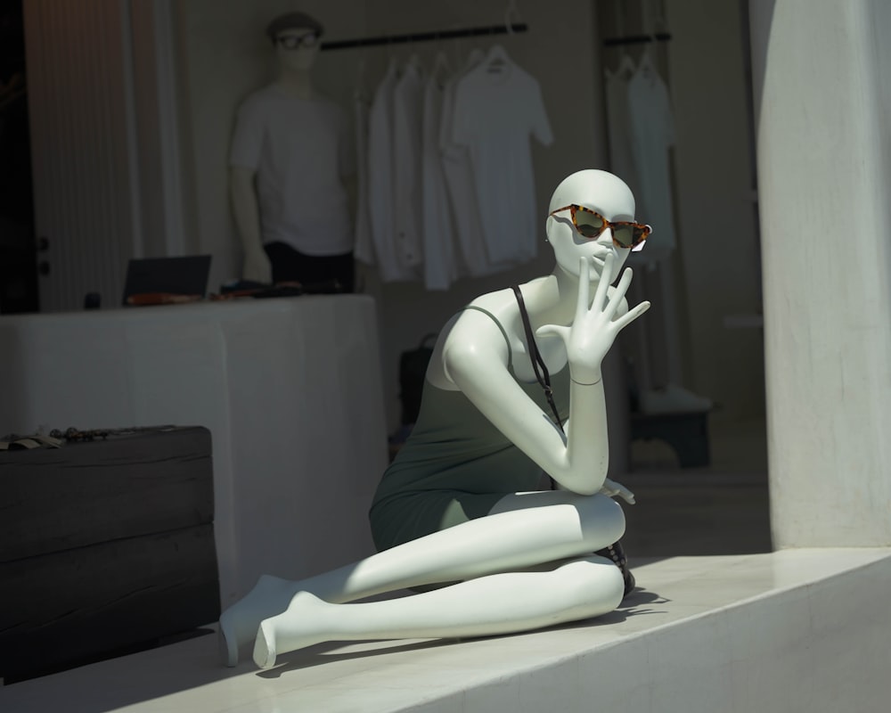 a mannequin wearing a white mask and a white suit