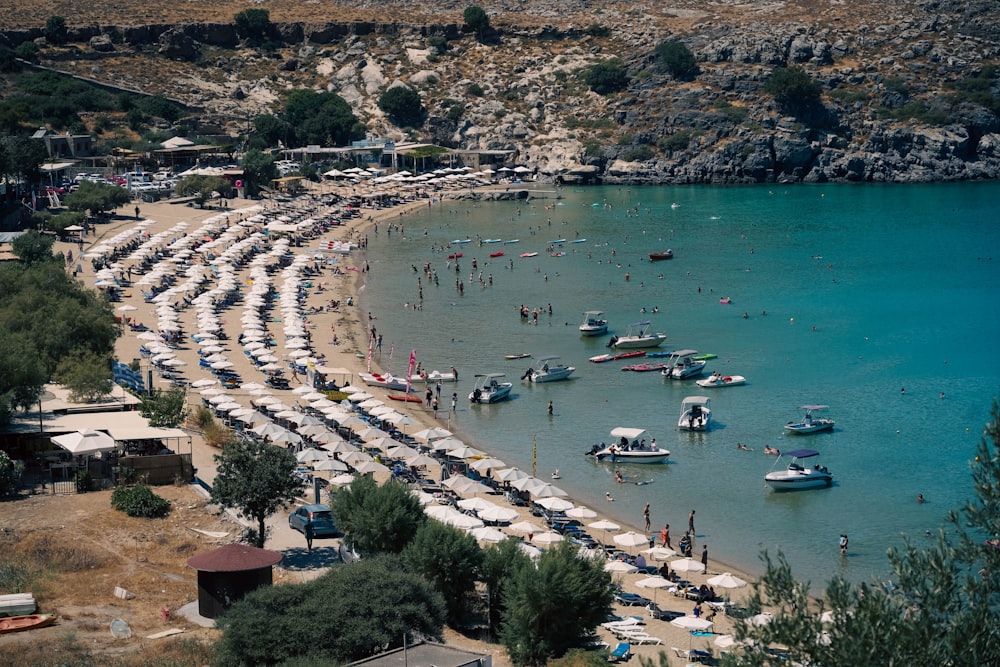 a beach with boats and people