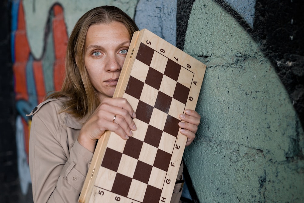 a woman holding a large piece of wood