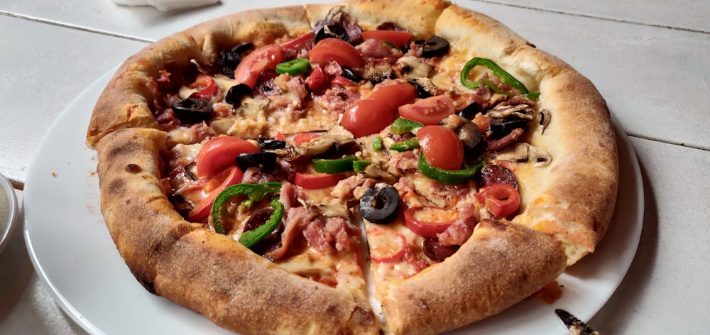 a pizza with tomatoes and olives