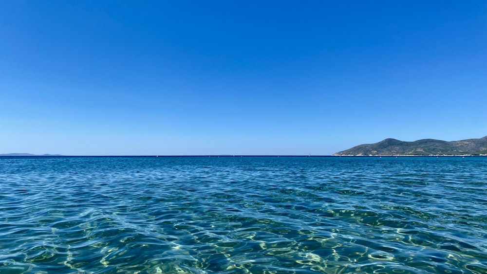 a body of water with islands in the distance