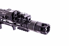 Close-up of detailed airsoft replica guns with tactical accessories.