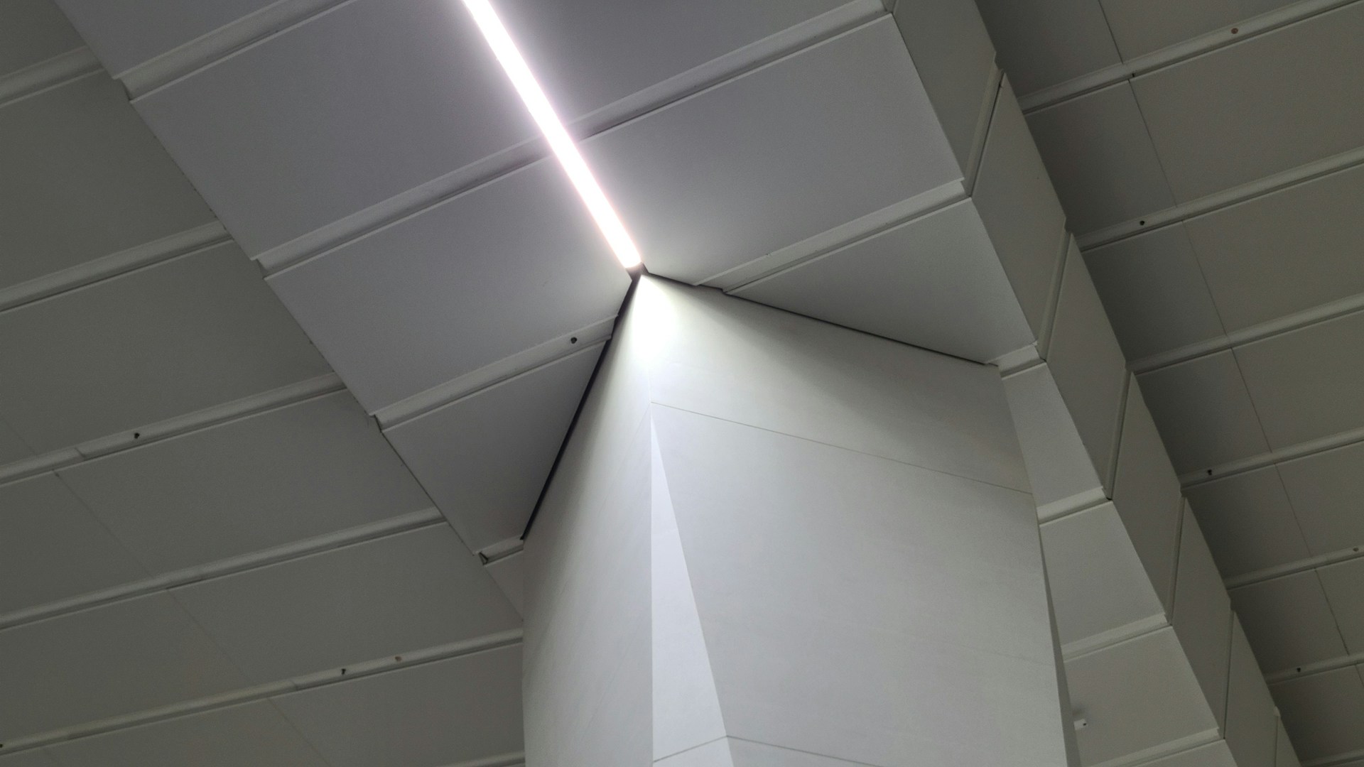 A modern architectural space featuring integrated audio panels and subtle automation controls blending seamlessly into the design.