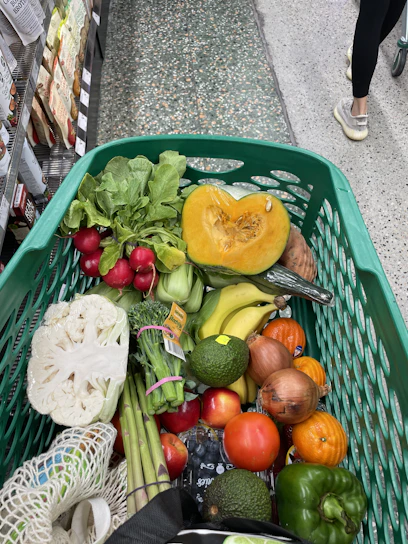 A vibrant display of fresh groceries and household items neatly arranged in a shopping cart.