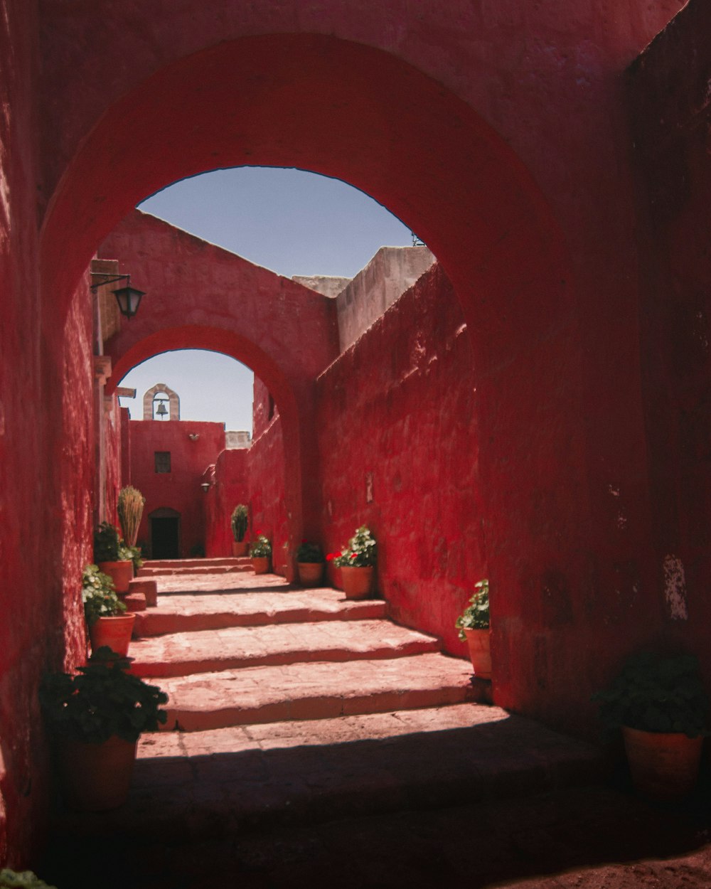 a stone staircase with potted plants