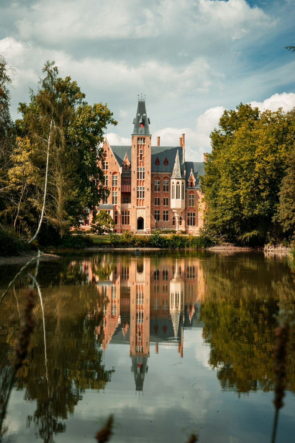 a large building with a pond in front of it