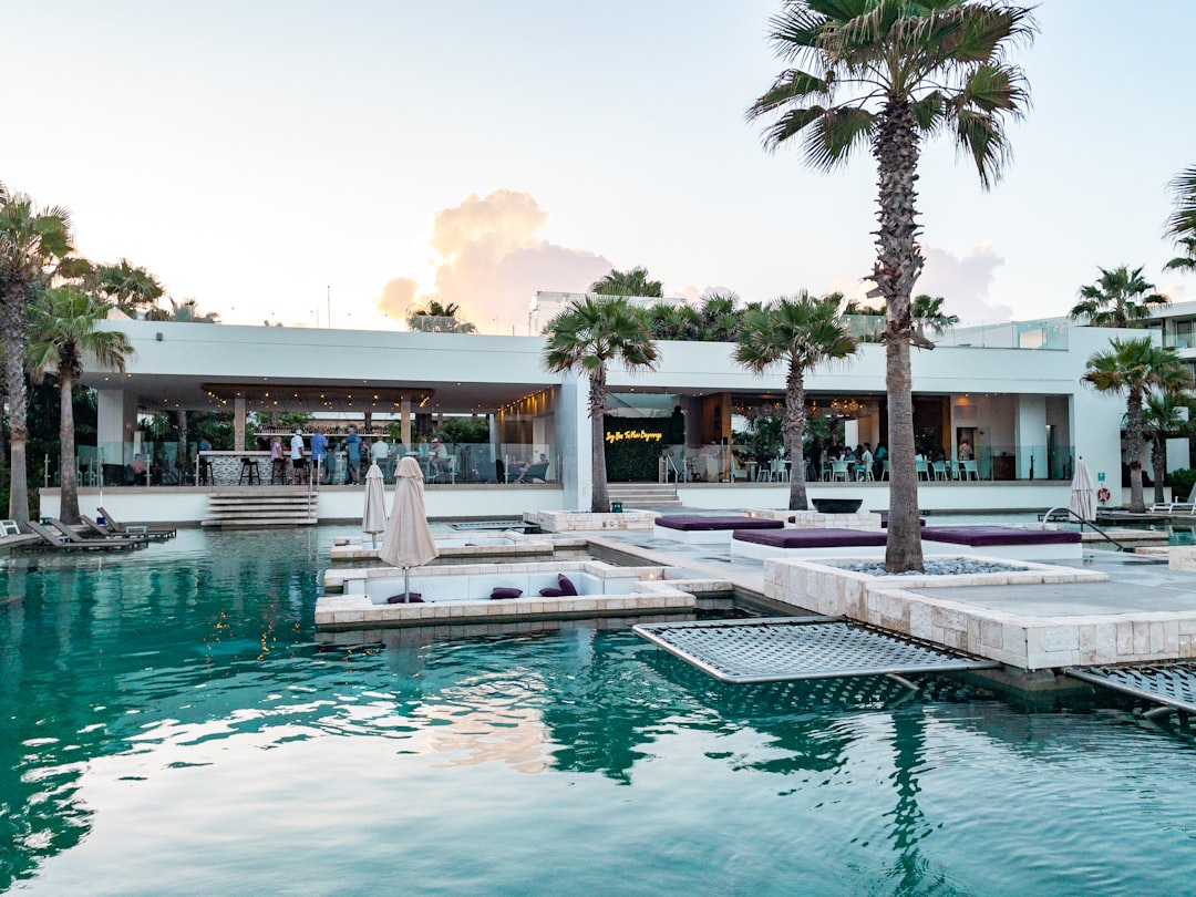 a pool with a building in the background,