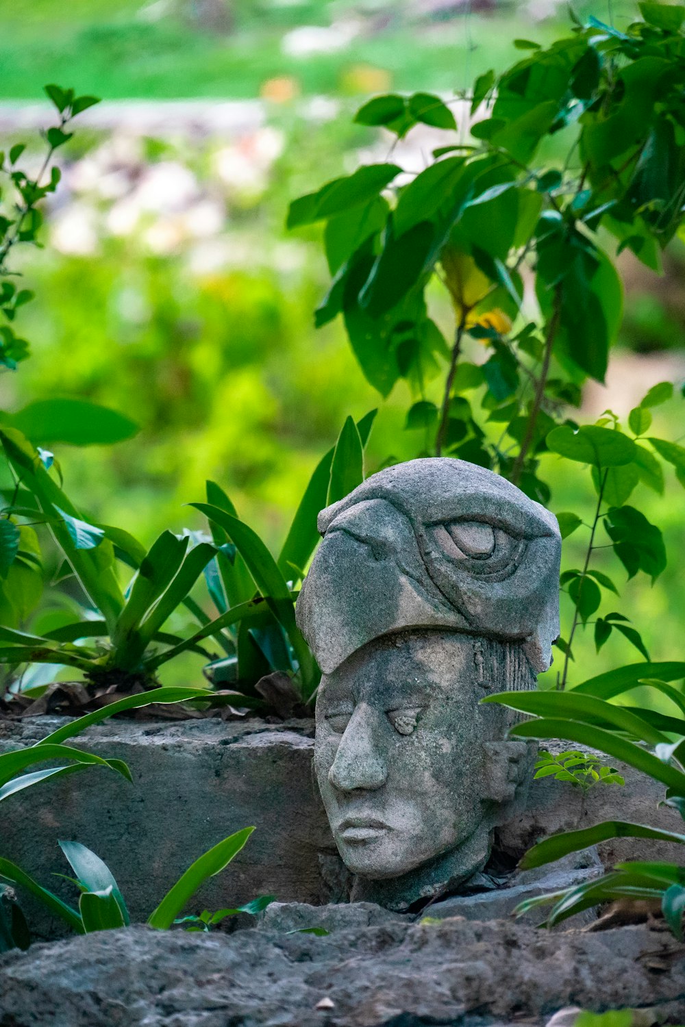 a statue of a person with plants around it