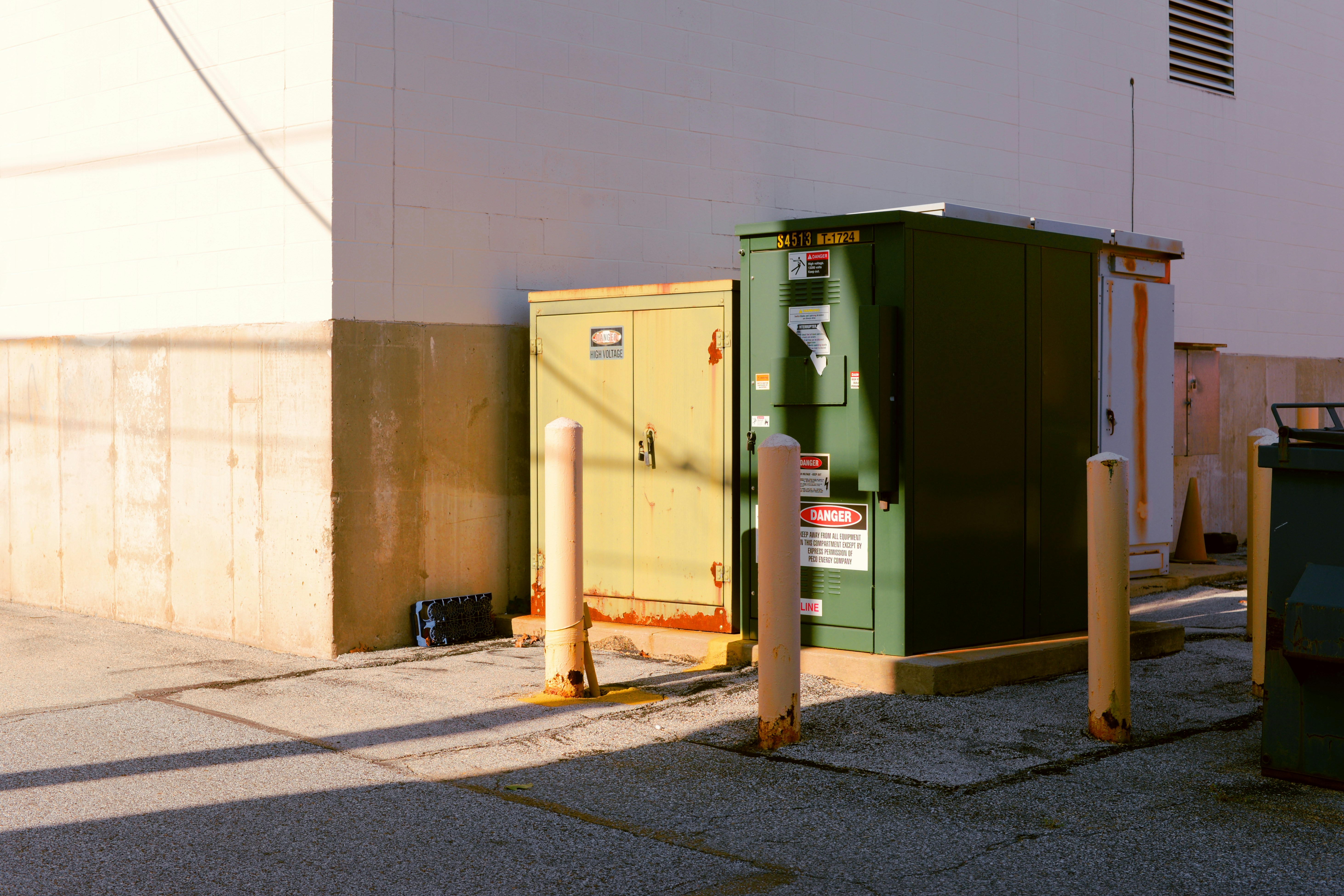 Several electric delivery vans parked at a depot and charging at night