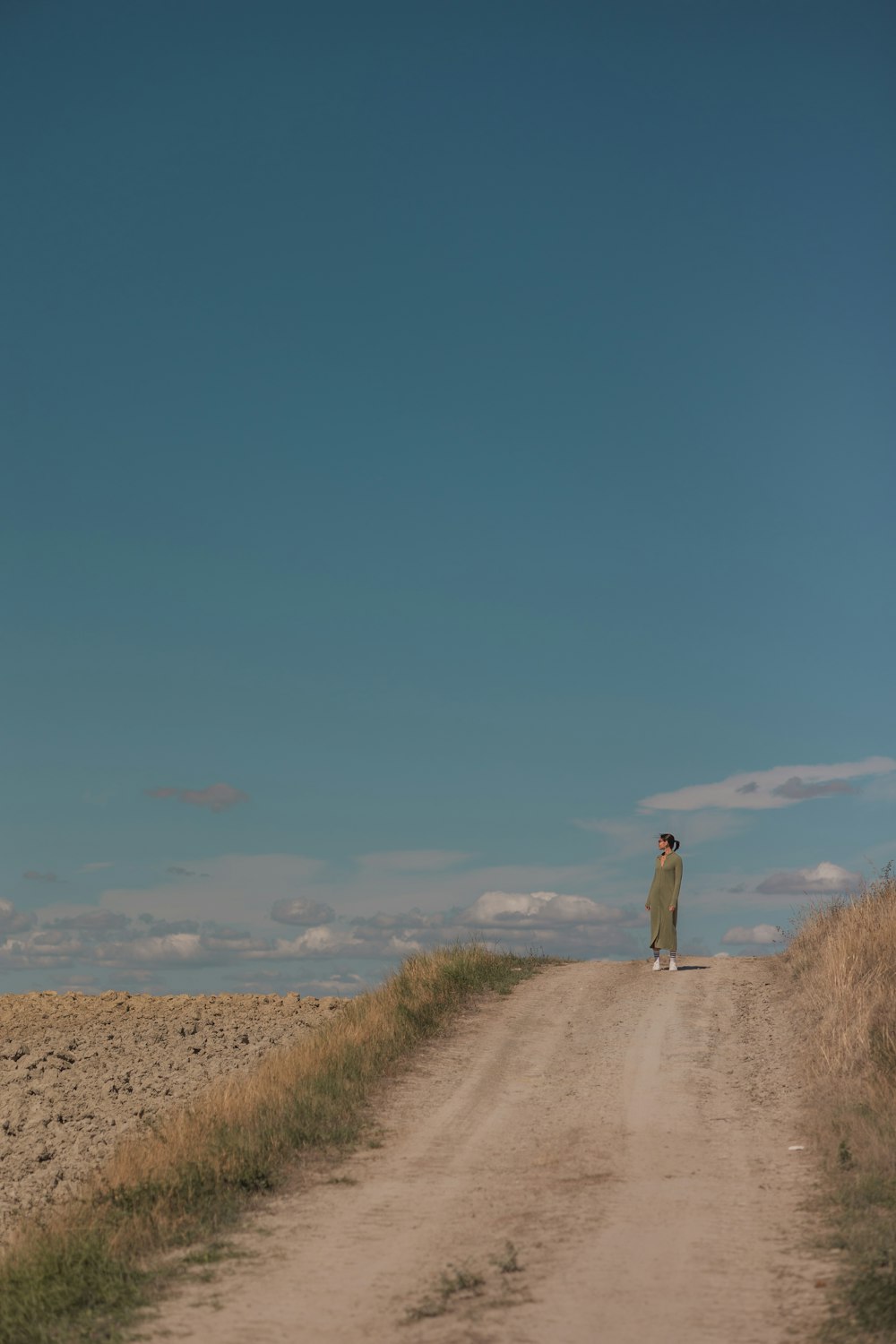 a person walking down a dirt road