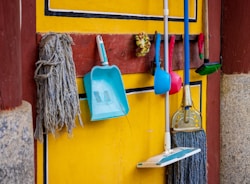 a yellow wall with a blue and white towel from it