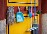 a yellow wall with a blue and white towel from it