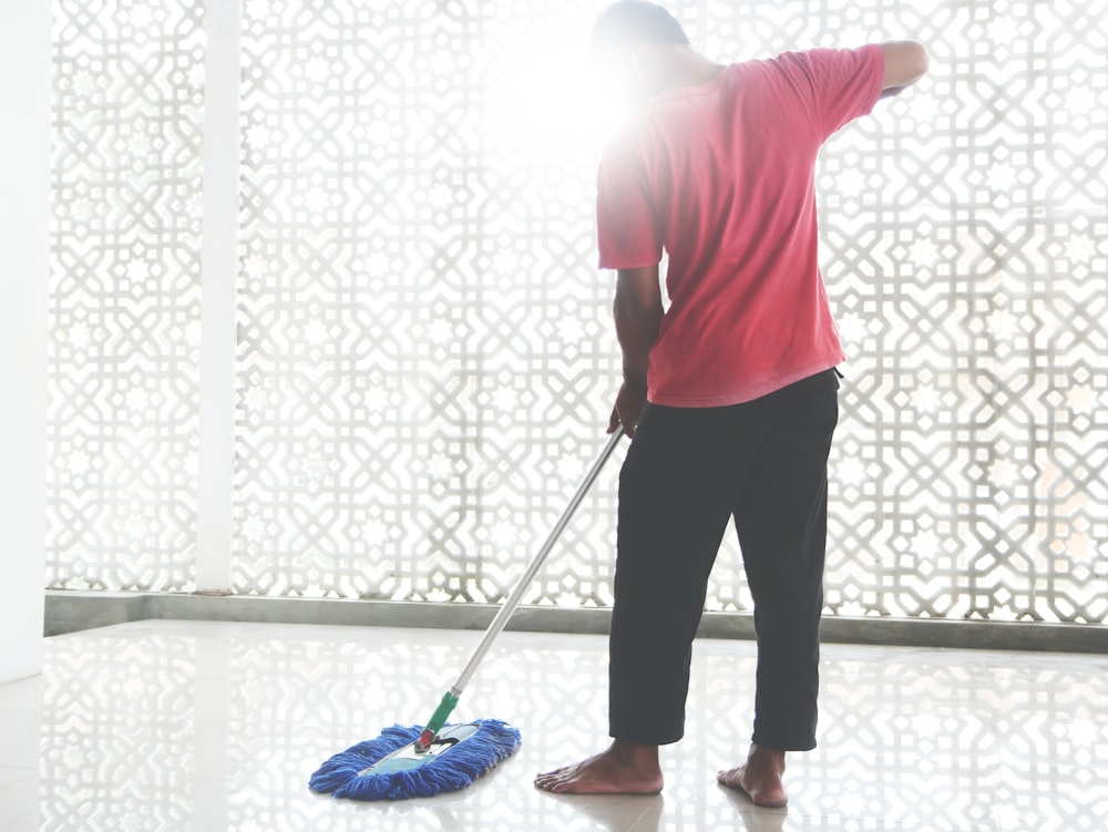 a person with a broom and a bucket