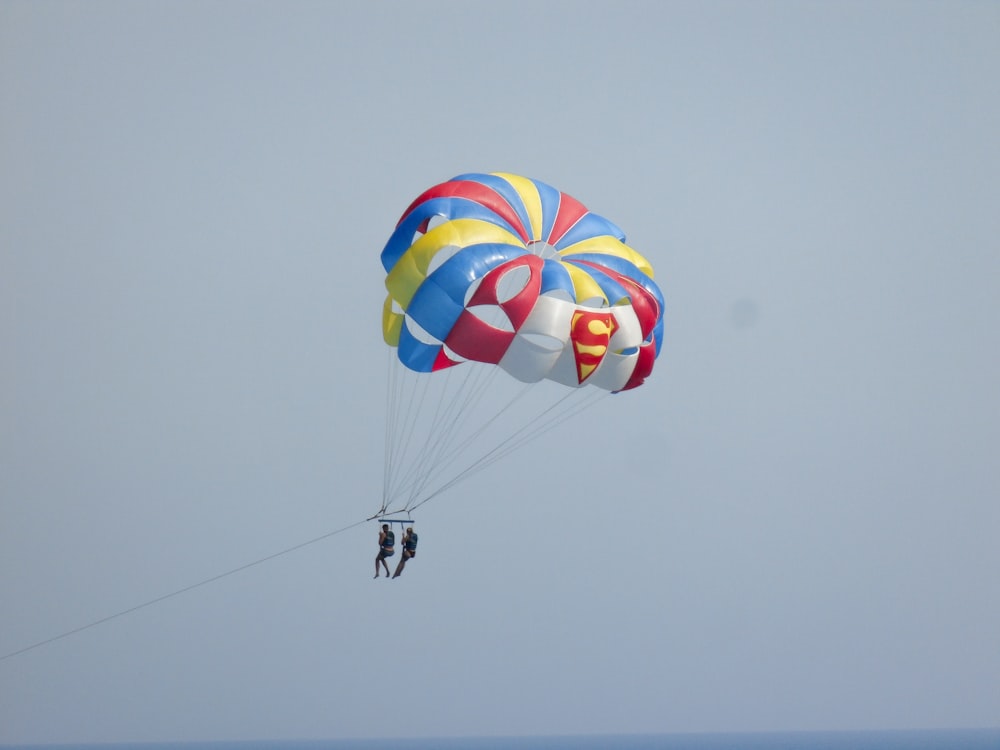 a couple people parachuting