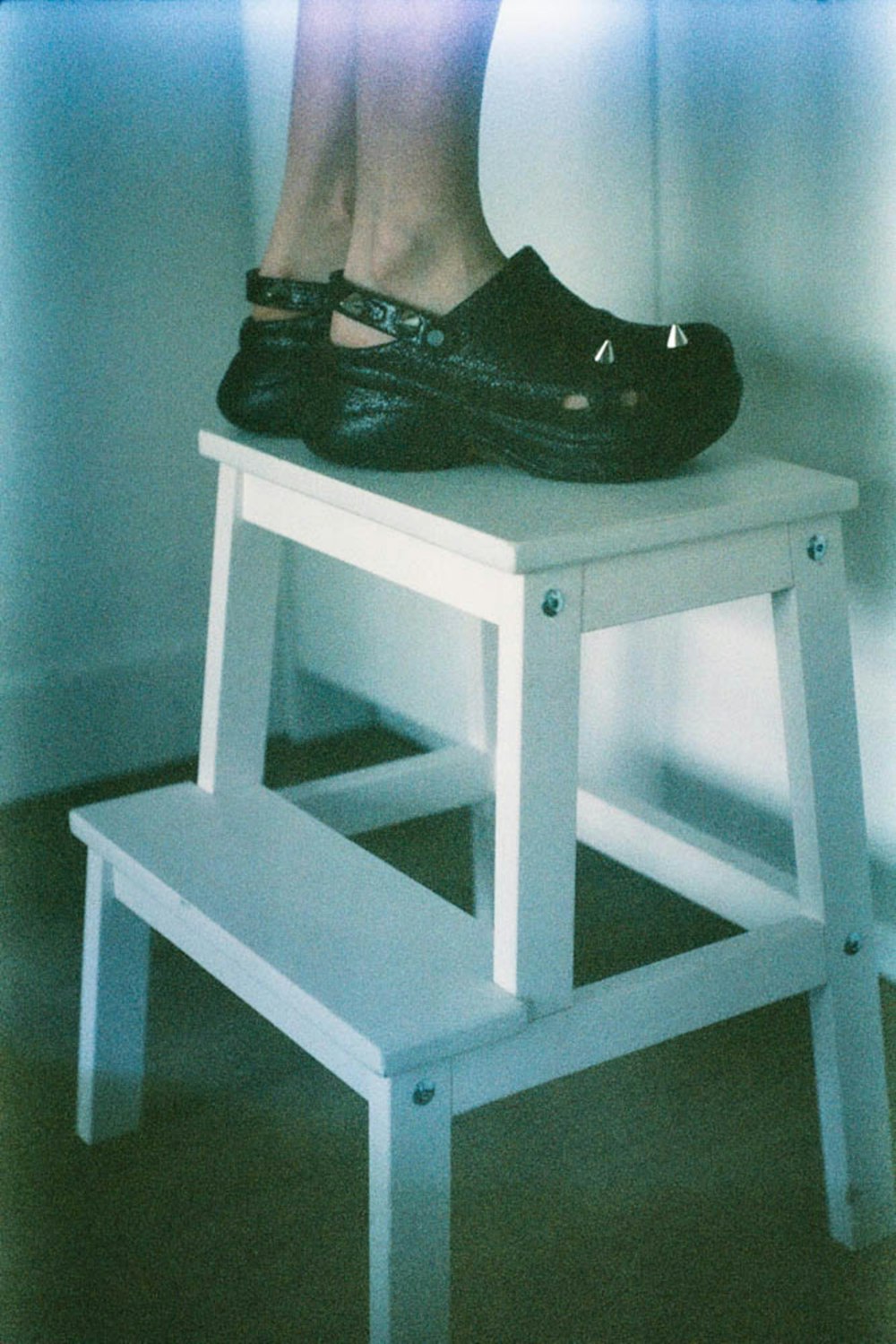 a person's feet on a white table