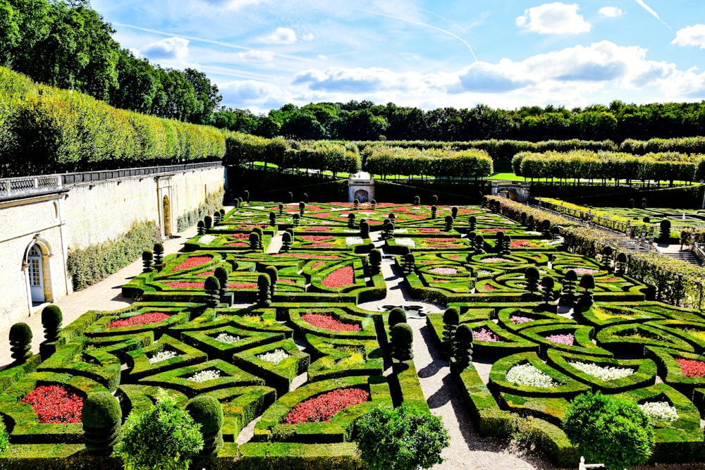 a garden with flowers with Château de Villandry in the background