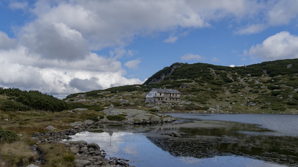 a house on a hill by a body of water