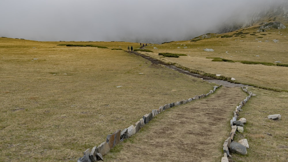 a long road with rocks on the side