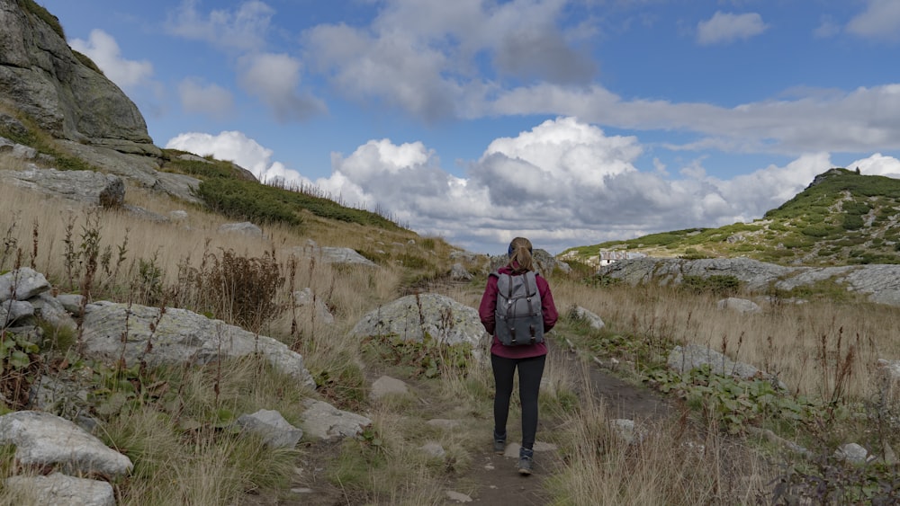 a person walking on a trail in a rocky area