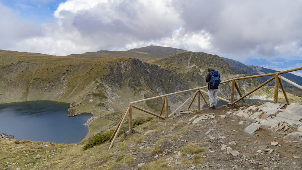 a person walking on a bridge over a river