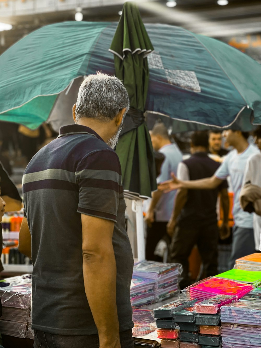 a person stands under an umbrella