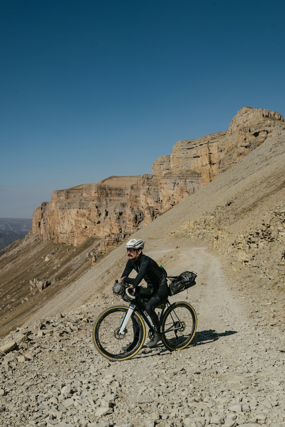 a man on a bike on a rocky hill