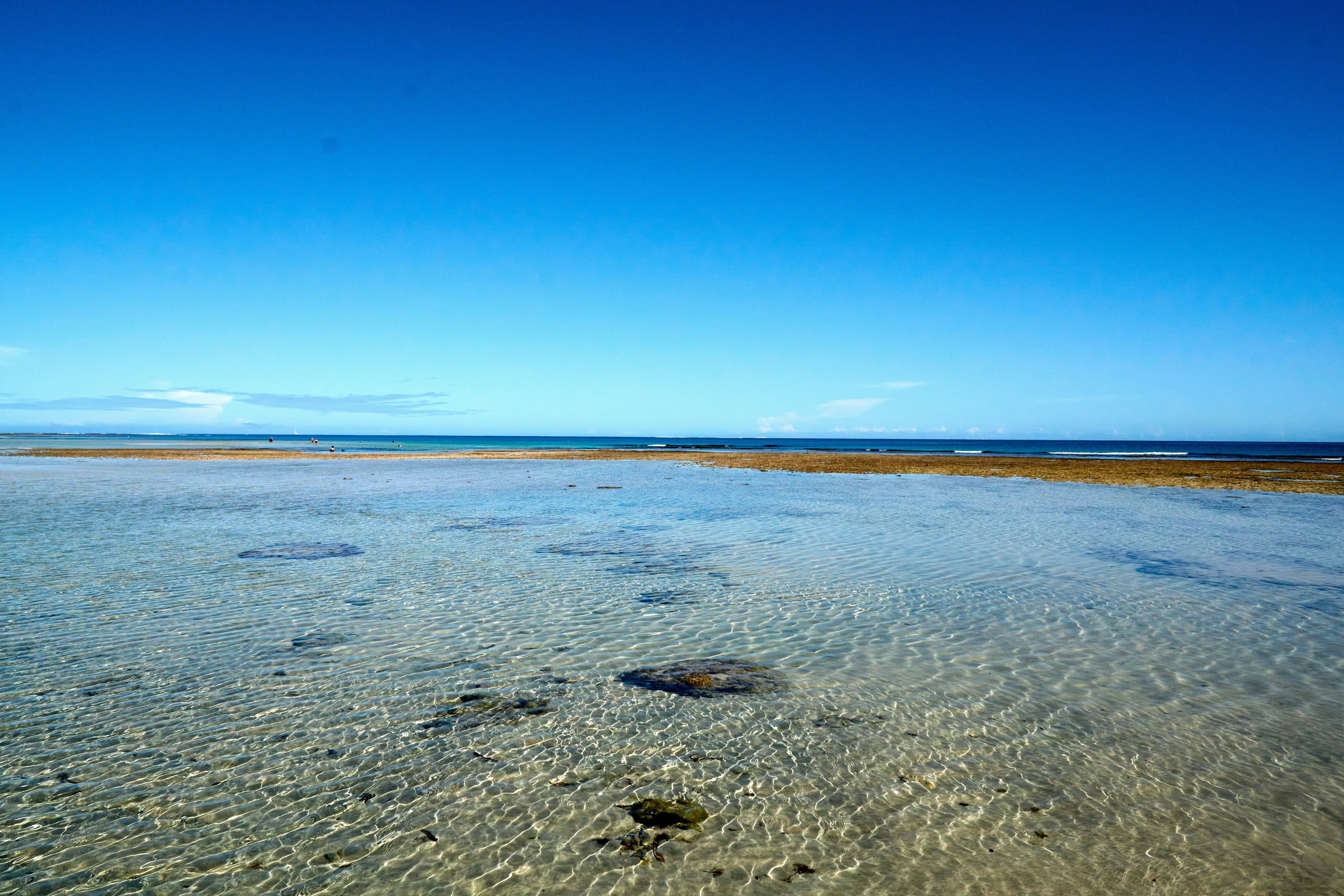 a large flat area with a body of water in the distance, 