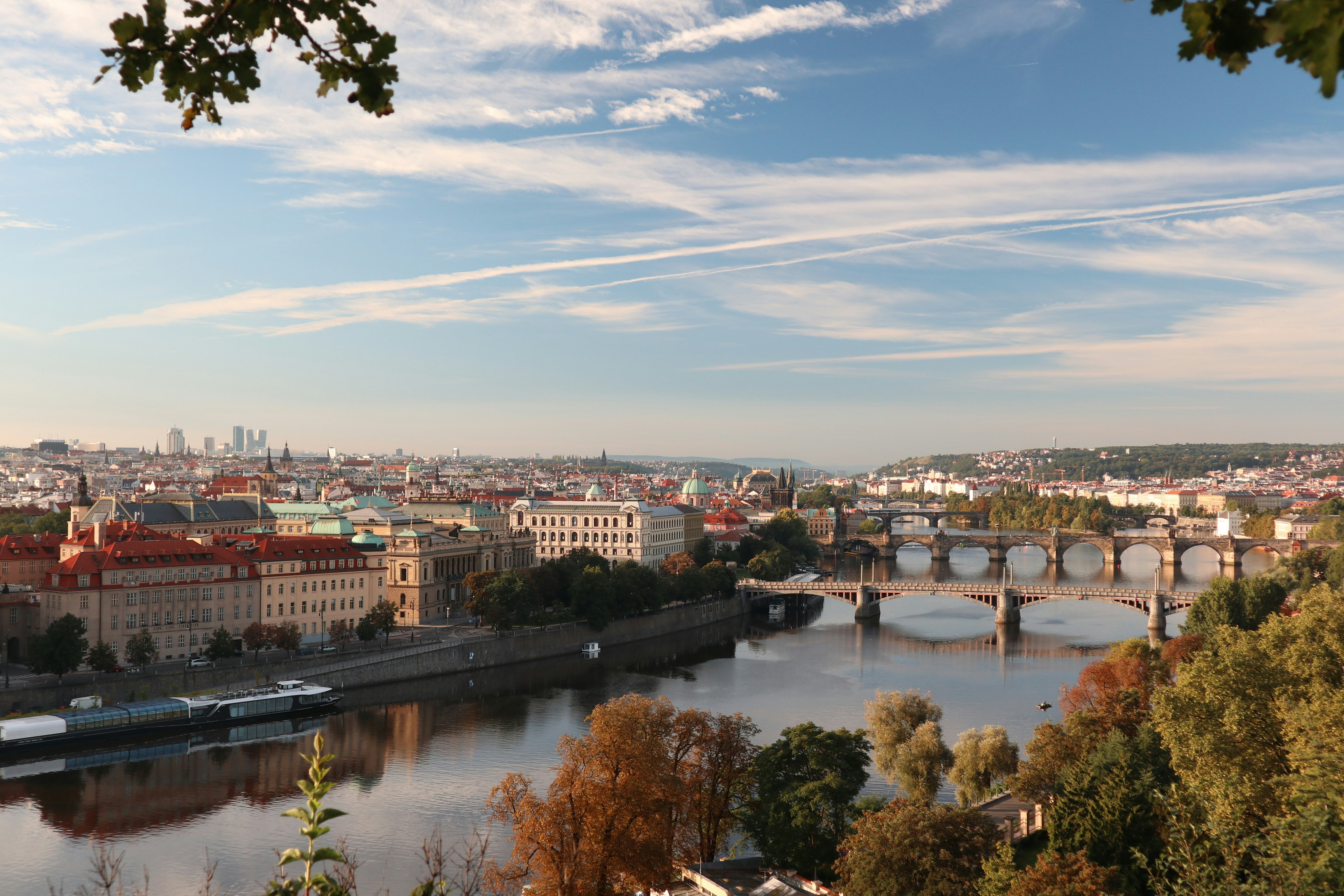 a river with a bridge and buildings, 