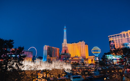 a city with a ferris wheel and buildings at night
