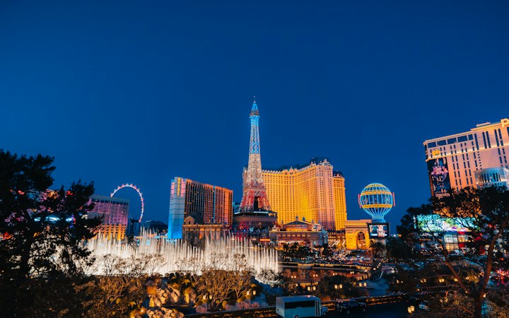 The Las Vegas skyline at night, the visitor economy that funds a large share of the Nevada state budget