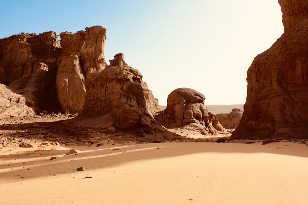 a sandy beach with large rocks