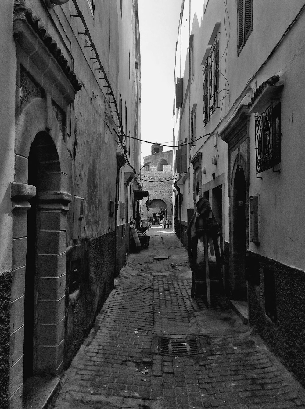 a cobblestone street with buildings on both sides