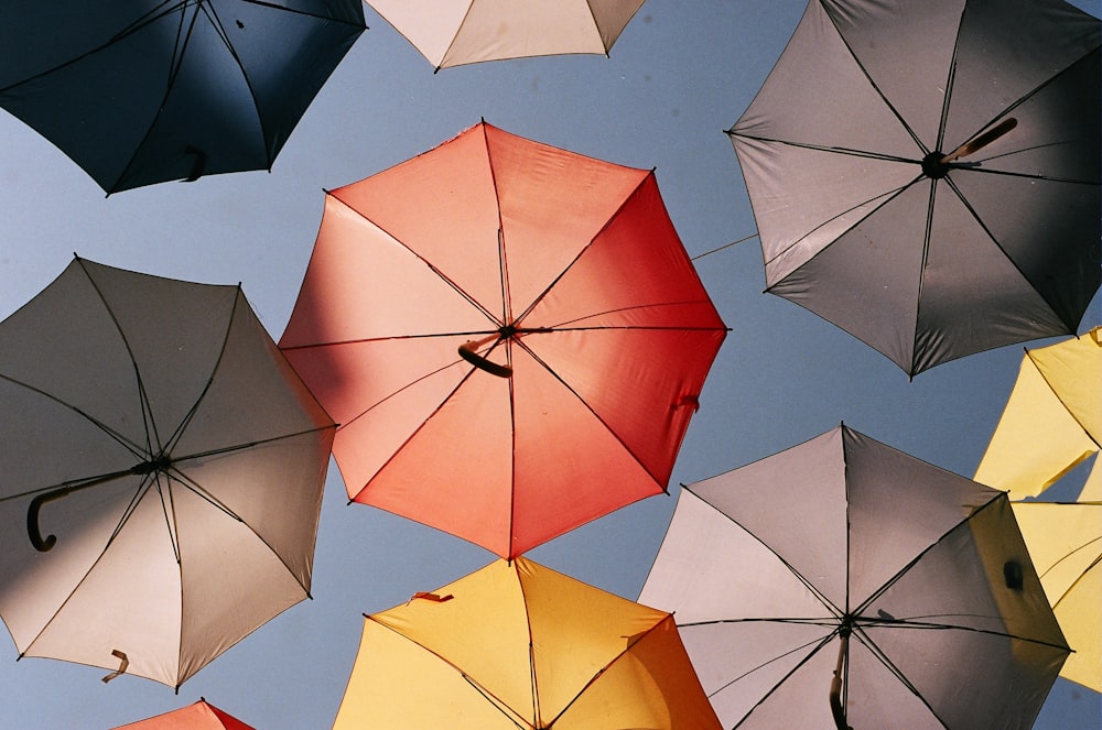 several umbrellas are from the ceiling