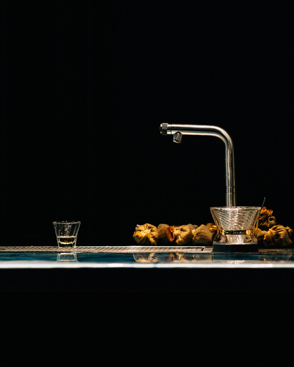 a faucet with water running into a glass of water