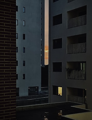 Wide shot of apartment buildings with sunset lighting.