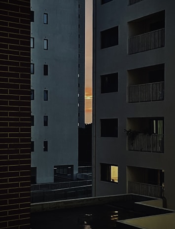 Exterior view of a contemporary high-rise luxury apartment building at sunset
