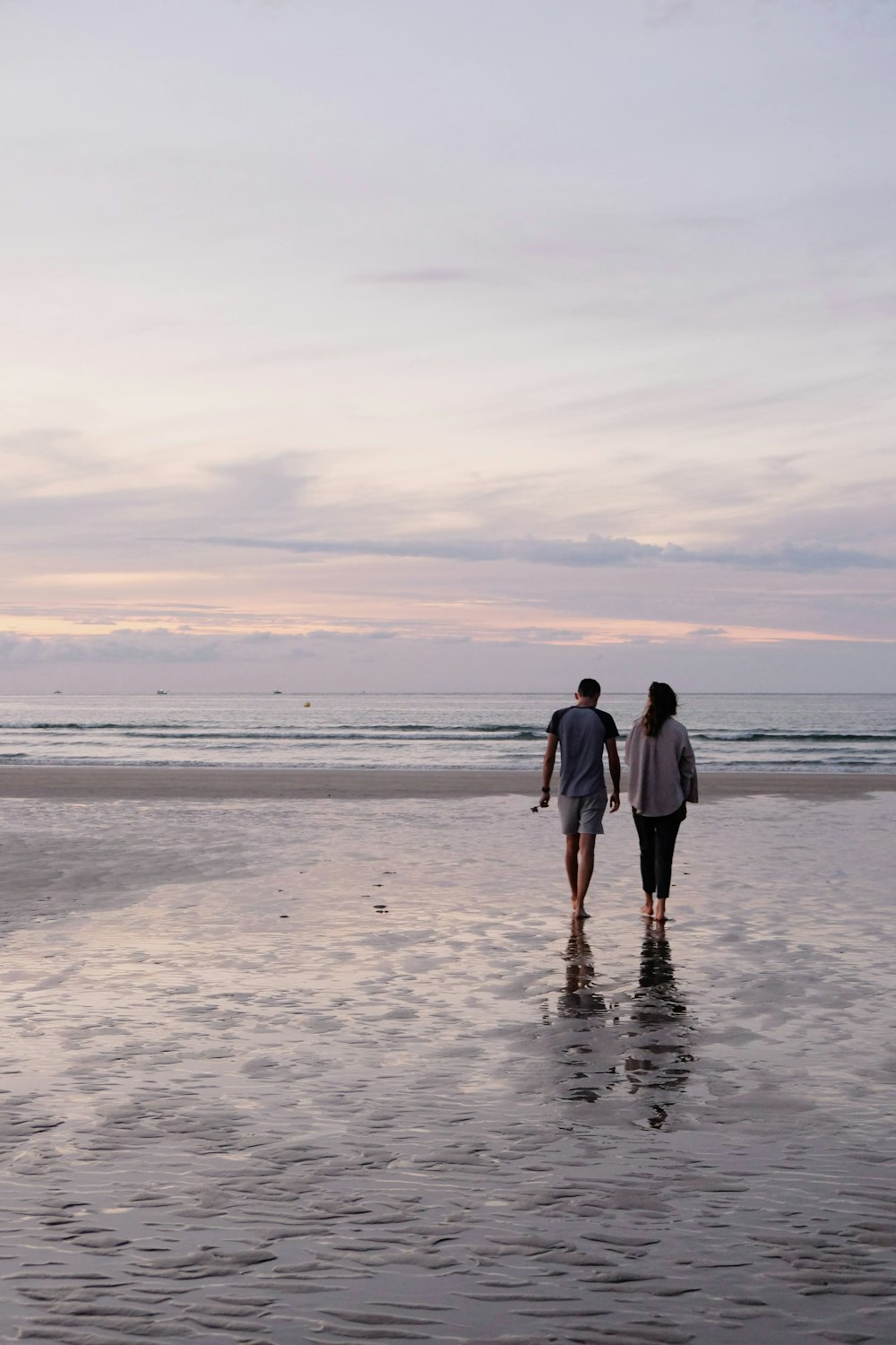 a couple walking on a beach