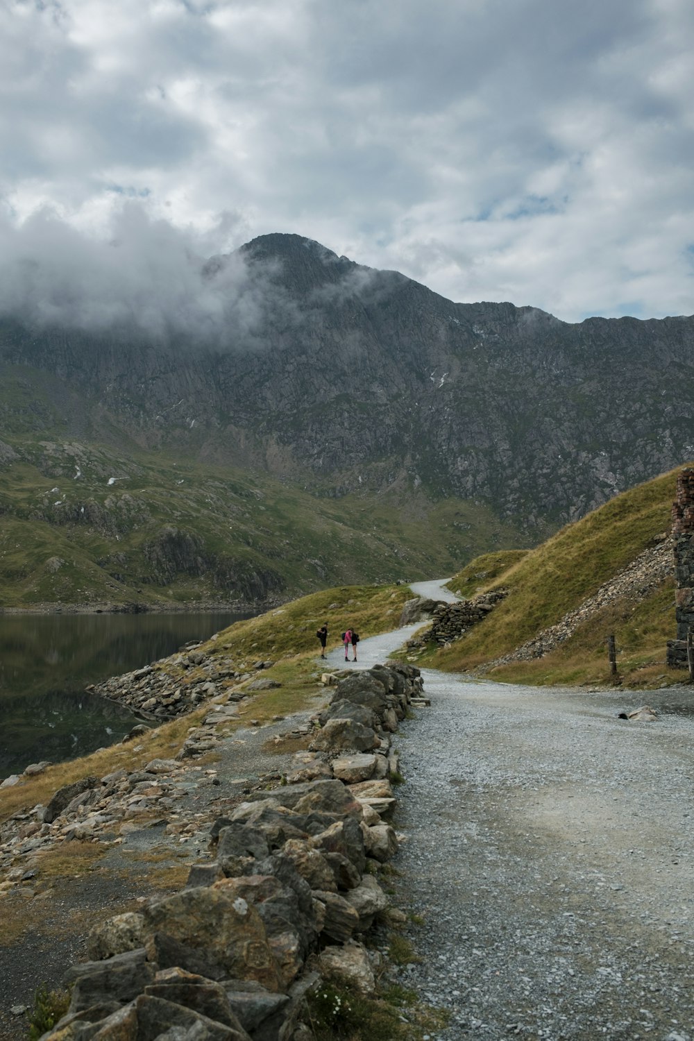 people walking on a path in a mountainous region