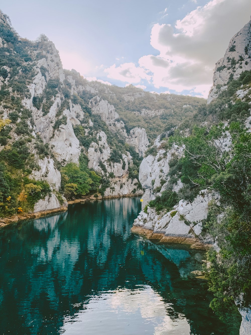 a river with a rocky mountain in the background