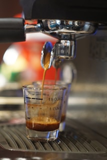 a glass of liquid with a straw