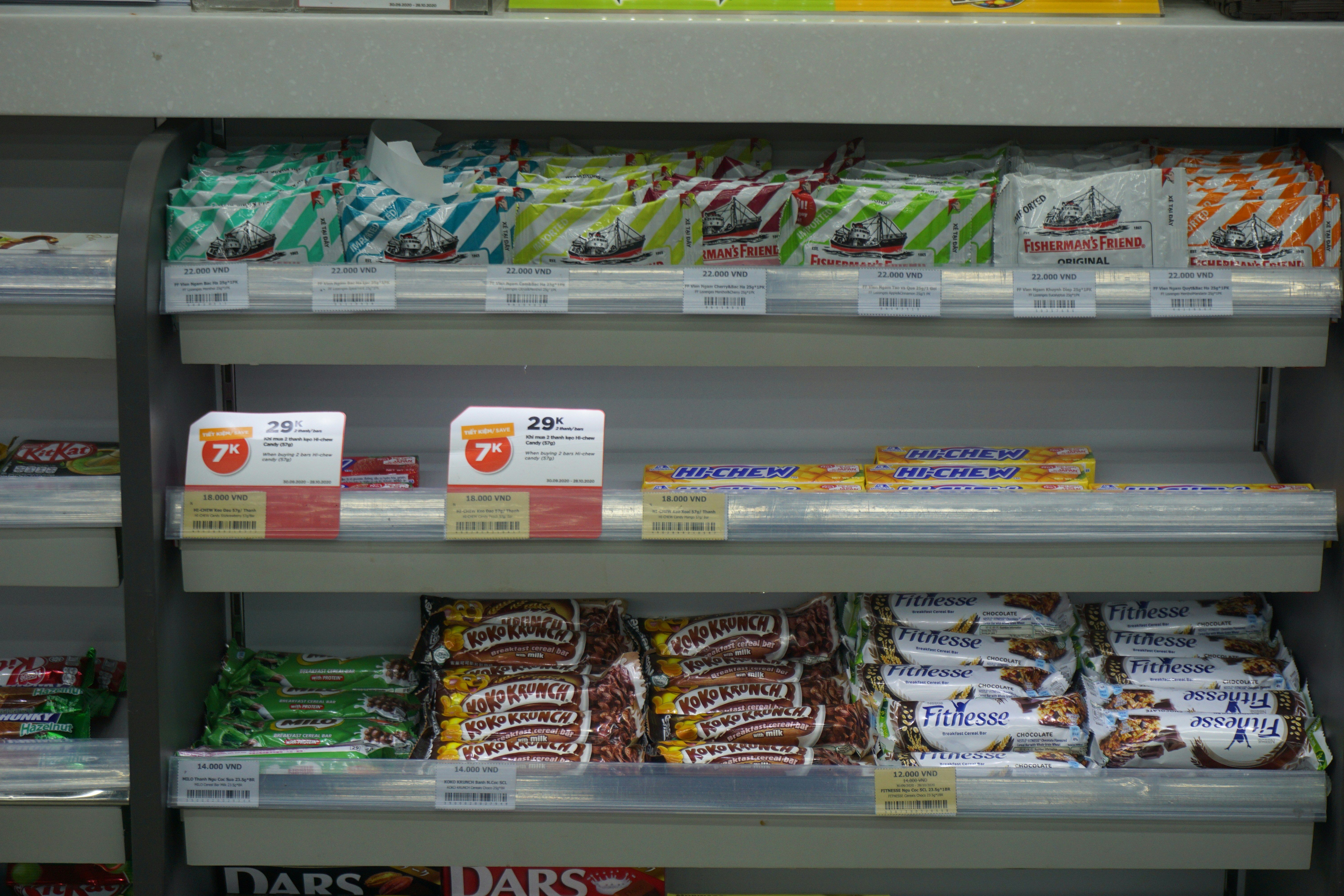 Supermarket shelf of packaged food with price labels
