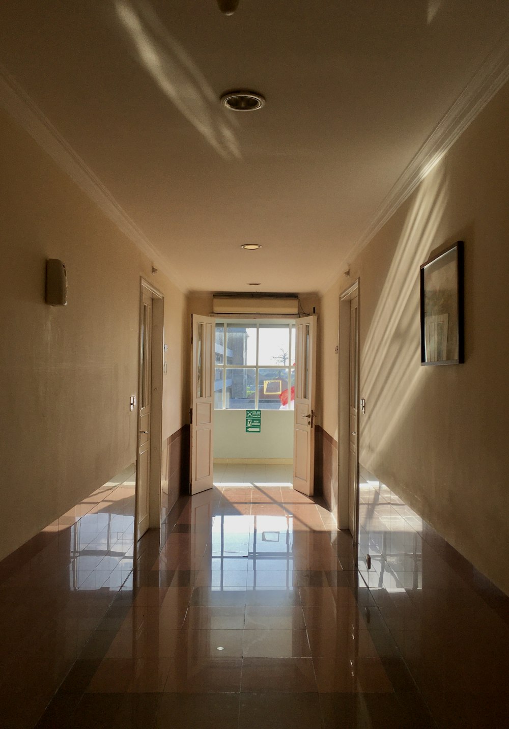 a hallway with a glass door